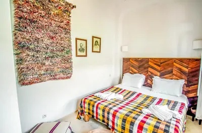 a bedroom with a bed and a painting on the wall at Riad Villa Almeria Hotel & Spa in Marrakech
