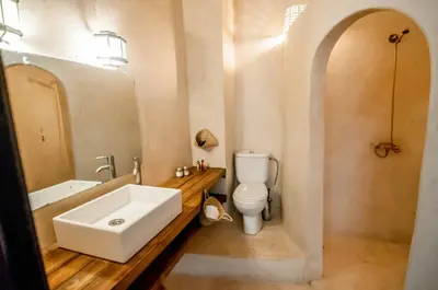 a bathroom with a white sink and a toilet at Riad Villa Almeria Hotel & Spa in Marrakech