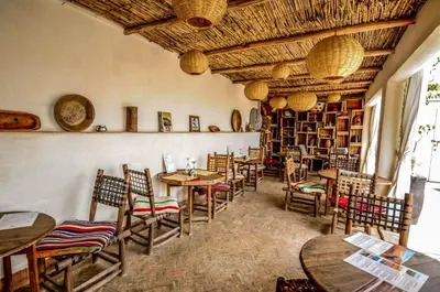 a restaurant with tables and chairs in a room at Riad Villa Almeria Hotel & Spa in Marrakech