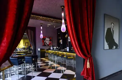 a restaurant with a checkered floor and red curtains at Adam Park Marrakech Hotel & Spa in Marrakech