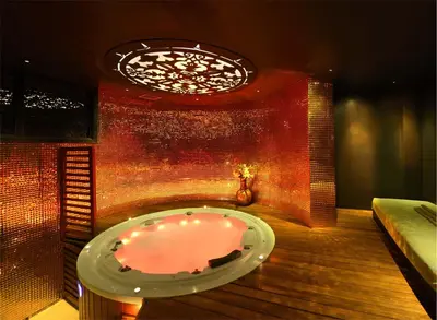 a hot tub in a room with a brick wall at Adam Park Marrakech Hotel & Spa in Marrakech