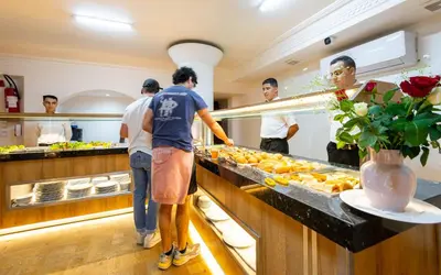 a group of people in a kitchen preparing food at Hotel Oudaya & Spa in Marrakech