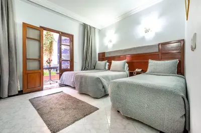 a hotel room with two beds and a window at Hotel Oudaya & Spa in Marrakech