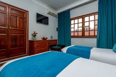 a hotel room with two beds and a window at Hotel Oudaya & Spa in Marrakech