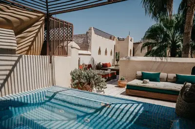a swimming pool in a patio with a couch at Riad Vert in Marrakech