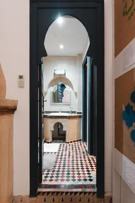 an archway leading into a room with a rug at The Central House Marrakech Medina in Marrakech