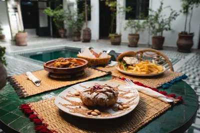 a table with plates of food on top of it at The Central House Marrakech Medina in Marrakech