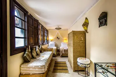 a living room with a couch and a window at Riad Dar Azul in Marrakech