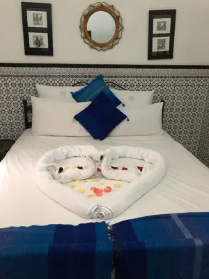a bed with two puppies in a heart shaped basket at Riad Dar Azul in Marrakech