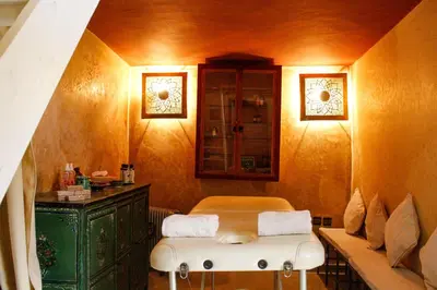 a room with a bed and a cabinet and a bench at Riad Dar Azul in Marrakech