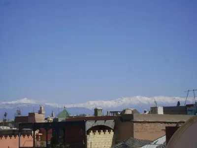 a view of the mountains from the roofs of buildings at Riad Dar Azul in Marrakech