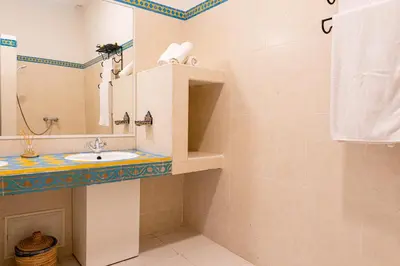 a bathroom with a sink and a mirror at Riad Le Marocain in Marrakech