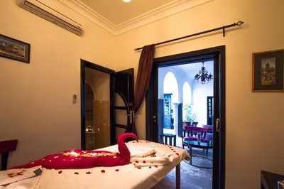 a bedroom with a bed with a swan on it at Ryad Amiran & Spa in Marrakech