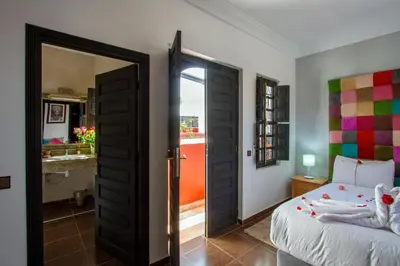 a bedroom with a bed and an open door at Ryad Amiran & Spa in Marrakech