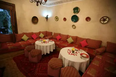 a living room with two tables and couches at Riad Alida in Marrakech