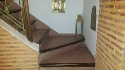 a set of stairs with a clock on the wall at Riad Alida in Marrakech
