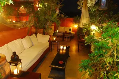 a living room with a white couch and some plants at La Terrasse Des Oliviers in Marrakech