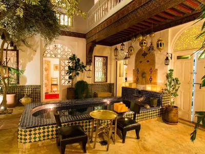 a lobby with a table and chairs in a building at La Terrasse Des Oliviers in Marrakech