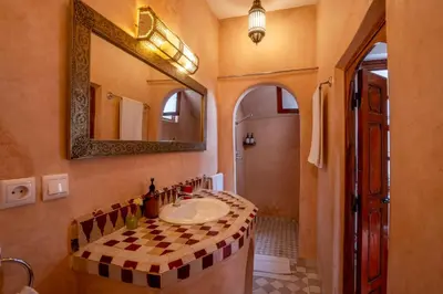 a bathroom with a sink and a mirror at Riad Nora in Marrakech