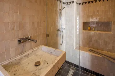 a bathroom with a bath tub and a shower at Riad Bab 54 in Marrakech