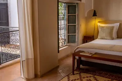 a bedroom with a bed and a balcony at Riad Bab 54 in Marrakech
