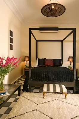a bedroom with a large bed with a large mirror at Riad Elizabeth in Marrakech