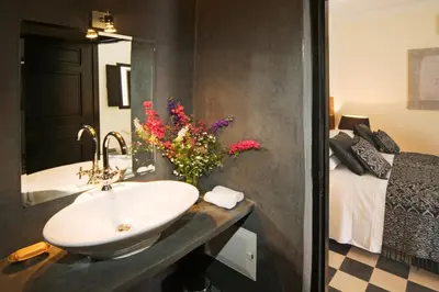 a bathroom with a sink and a bed with flowers at Riad Elizabeth in Marrakech