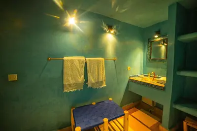 a bathroom with a sink and a blue wall at Riad Euphorbe in Marrakech