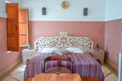 a bedroom with a large white bed in a room at Riad Euphorbe in Marrakech