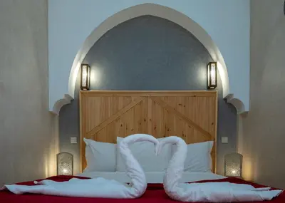 two swans making a heart on a bed at Riad Le Plein Sud in Marrakech