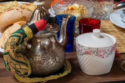 a table with a tea kettle and a candle at Riad Le Plein Sud in Marrakech