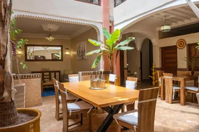a dining room with a wooden table and chairs at Riad Le Plein Sud in Marrakech