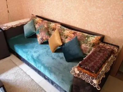 a couch with pillows on it in a room at Relaxation apartment in Marrakech