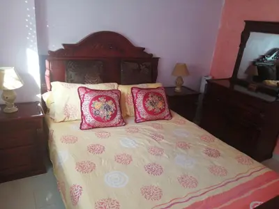 a bedroom with a large bed with pink pillows at Relaxation apartment in Marrakech
