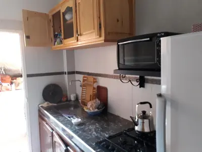 a small kitchen with a stove and a microwave at Relaxation apartment in Marrakech