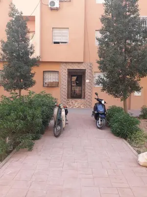 two scooters parked in front of a building at Relaxation apartment in Marrakech
