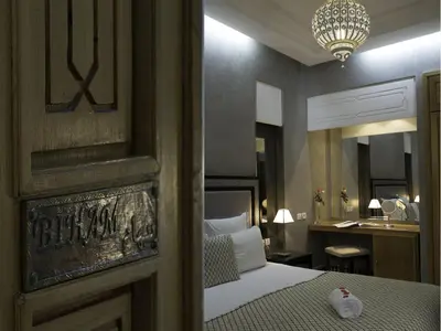 a hotel room with a bed and a mirror at Riad L'Etoile D'Orient in Marrakech