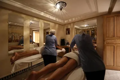 a group of people in a room with beds at Riad L'Etoile D'Orient in Marrakech