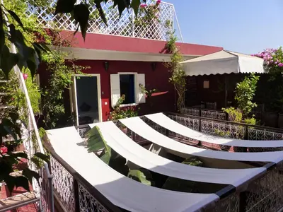 a house with white steps in front of a building at Riad Marhbabikoum in Marrakech