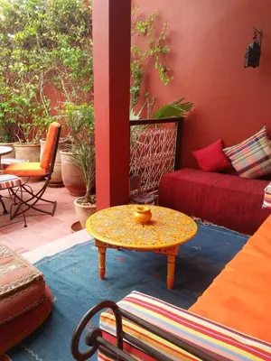 a living room with a table and a couch at Riad Marhbabikoum in Marrakech