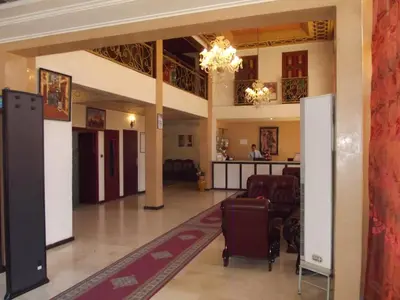 a lobby of a hotel with a waiting room and luggage at Hotel Al Kabir in Marrakech