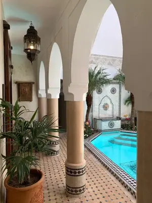 a courtyard with a swimming pool in a building at Riad Abaka hotel & boutique in Marrakech