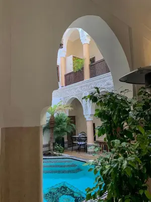 a courtyard with a swimming pool in a building at Riad Abaka hotel & boutique in Marrakech