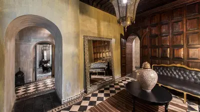 a room with a couch and a table and a mirror at Dar Darma in Marrakech