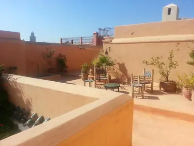 a balcony with a table and chairs on a building at Dar El Kharaz in Marrakech