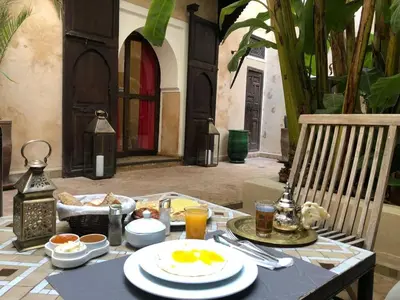 a table with plates of food on top at Riad Bamileke in Marrakech