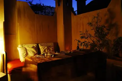 a dark room with a table with a tableablish at Riad Bamileke in Marrakech