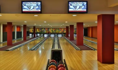 a bowling alley with lanes and televisions at Grand Plaza Marrakech in Marrakech