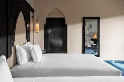 a bedroom with a large bed with white pillows at Grand Plaza Marrakech in Marrakech