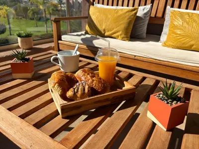 a tray of bread and orange juice on a wooden table at Marrakech golf city prestigia in Marrakech